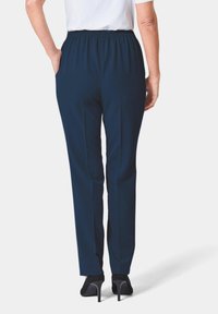 Navyblauwe pull-on broek met elastische tailleband, rechte pijpen en zijzakken. Glad materiaal en een strak ontwerp.