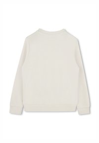 Sweatshirt beige clair, avec un col rond, des manches longues et des poignets côtelés. Fabriqué en coton texturé avec une finition lisse.