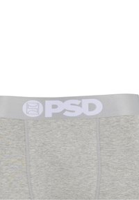 Boxers gris clair avec une large ceinture élastique grise portant le logo PSD blanc et un symbole centrés à l'avant.