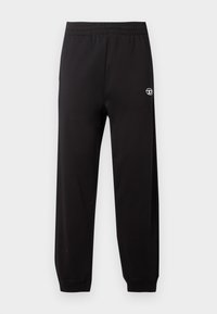 Sorte sweatpants har en elastisk talje, tætsiddende ben og et lille hvidt logo på venstre side. Stoffet har en glat tekstur.