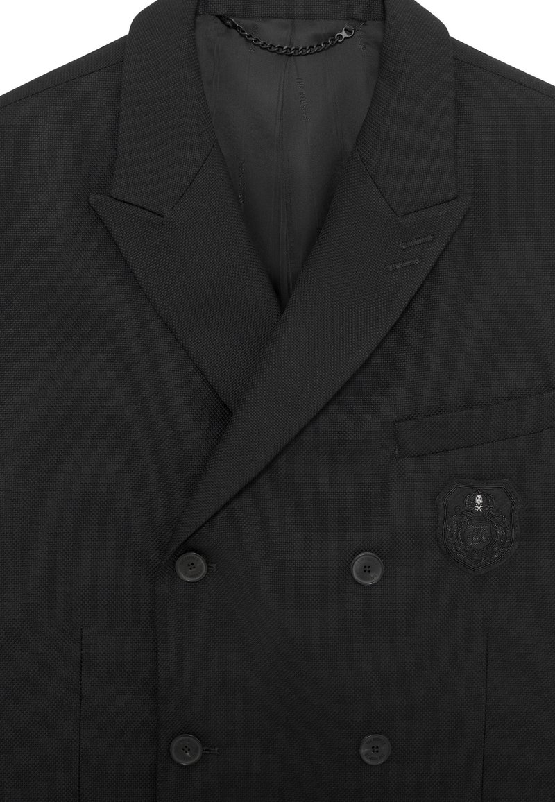 Zwarte dubbelgeknoopte blazer, gebreide stof, met notch lapels, twee knopen, linker borstzak met een zwart embleemdetail.