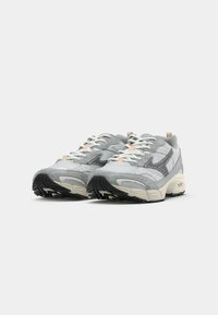 Gray running shoes with mesh and suede upper, white laces, and gray rubber sole. Features perforations for breathability and branding details.