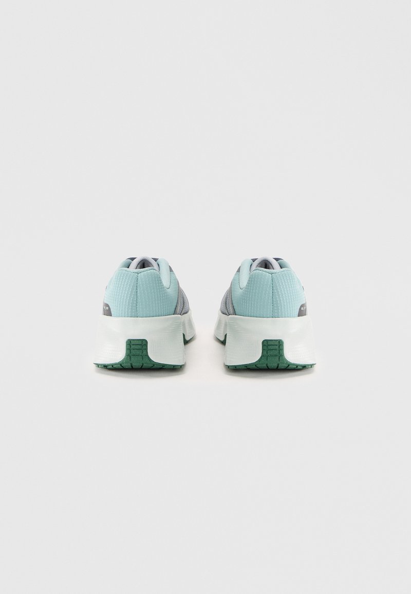 Zapatillas deportivas azul claro y gris con un upper texturizado, cuello acolchado y suela verde. Presenta una media suela blanca acolchada para mayor soporte.