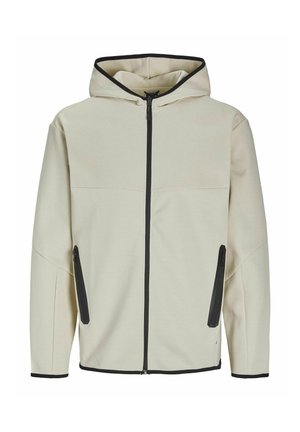 Ljusbeige hoodie i mjukt tyg, har en hel dragkedja, två sidfickor med dragkedja och kontrasterande svarta detaljer och kanter.