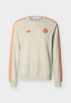 Crèmekleurige sweatshirt met lange mouwen, met oranje Adidas-strepen op de mouwen en oranje logo's op de borst.