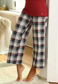 Plaid pajama pants in grey, red, and blue, featuring a loose fit and soft fabric. Pants have wide legs and a relaxed waistband.