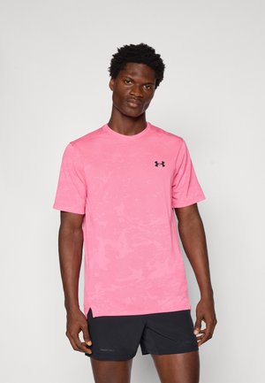 Pink athletic T-shirt with short sleeves, textured fabric, round neckline, and side slits. Features a black logo on the chest.