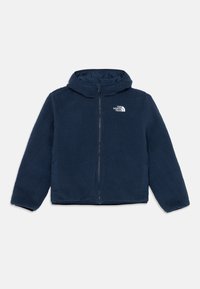 Veste en polaire de couleur bleu marine foncé, avec une fermeture éclair et une capuche. Présente une texture douce et un logo blanc sur la poitrine gauche.