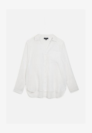 Chemise blanche à manches longues, boutonnée, avec un col, une poche poitrine et une coupe décontractée. Fabriquée en tissu léger et légèrement texturé.