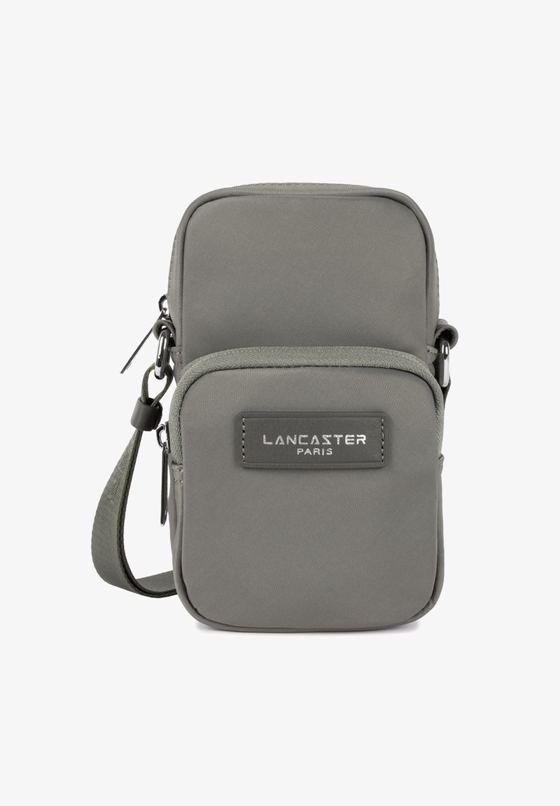 Petit sac bandoulière gris avec deux compartiments zippés et une sangle réglable, présentant un patch logo "Lancaster Paris" sur la poche avant.
