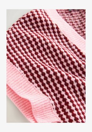 Knitted fabric scarf in pink and burgundy with a houndstooth pattern. Features a ribbed edge along the bottom, creating texture and contrast.