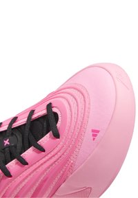 Pink athletic shoe with a textured upper, black laces, and a sleek design. Notable details include soft material and contrasting accents.