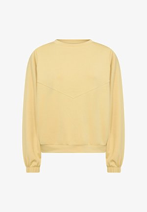 Dzeltena sporta krekls ar garām piedurknēm, apaļu kaklu un diagonālu šuvju detaļu krūšu daļā. Ribu aproces un apakšmalu. Mīksta tekstūra.