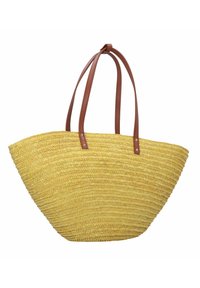 Geweven stro tote bag in geel met twee bruine leren handvatten; brede, ronde vorm; gestructureerde afwerking met een open ontwerp aan de bovenkant.