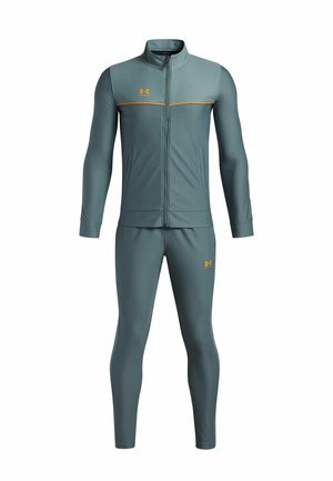 Track suit in dark teal, features a zip-up jacket with orange accents and logo, paired with matching fitted pants. Smooth fabric texture.
