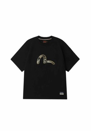 T-shirt nera in cotone con maniche corte, con una grafica a serpente dorato e testurizzato sulla parte frontale e un piccolo etichetta in basso a sinistra.
