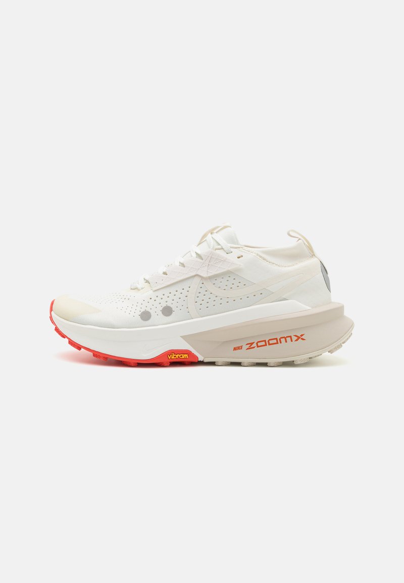 Der Nike ZoomX Laufschuh verfügt über ein Obermaterial aus weißem Mesh, graue Akzente und eine strukturierte rote Außensohle. Auffällige "ZoomX"-Markierung an der Seite.
