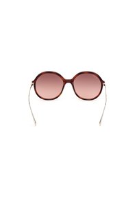 Occhiali da sole ovali marroni con lenti sfumate, sottili aste in metallo dorato e montatura in plastica liscia. Presenta un design elegante e moderno.