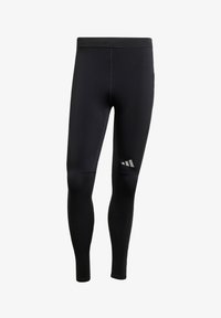 Leggings deportivos negros con una textura suave, que cuentan con acentos reflectantes y un diseño ajustado. Fabricados en un material elástico que absorbe la humedad.