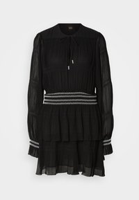 Black pleated dress with a round collar, long sleeves, and a drawstring. Features a tiered hem and a white zigzag-stitched waistband.
