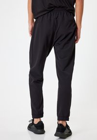 Koton SPORT - Pantalones deportivos - black