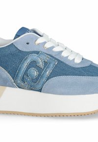 Blue sneaker featuring denim and suede materials, lace-up design, metallic logo detail, and a thick white sole with a textured bottom.