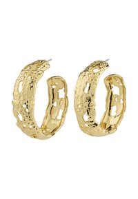 Boucles d'oreilles en métal doré texturé en forme de créoles, avec des motifs découpés irréguliers et une finition légèrement martelée.