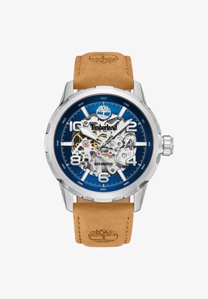 Timberland Automatik-Uhr mit blauem Ziffernblatt, silbernem Gehäuse und braunem Lederarmband. Verfügt über sichtbare Mechanik und gewagte Stundenmarker.