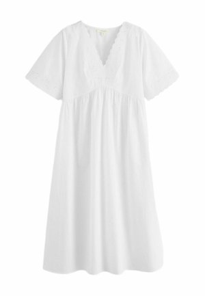 White knee-length dress with V-neck scalloped eyelet lace trim and short sleeves featuring matching eyelet lace detailing.