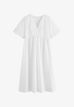 White knee-length dress with V-neck scalloped eyelet lace trim and short sleeves featuring matching eyelet lace detailing.