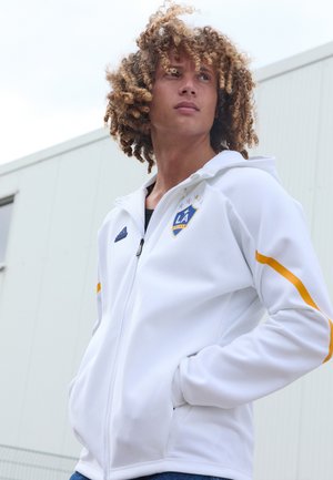 Witte zip-up hoodie van gladde stof, met blauwe en gouden accenten, een LA Galaxy-logo en zijzakken.