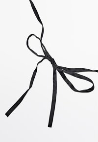 Black satin ribbon with a smooth texture, tied in a bow, features long, straight tails and a uniform width throughout.