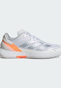 Valkoiset urheilusandaalit hopeisilla yksityiskohdilla, teksturoitu verkko-osa, oranssi kantapääkohdistus ja pehmustettu pohja, joka on suunniteltu nopeutta ja suorituskykyä varten.