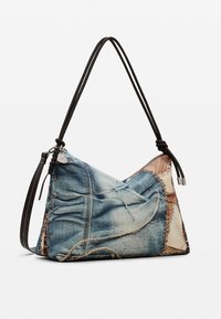 Bedruckte Handtasche aus Denim in dreieckiger Form, mit braunem Lederriemen, gestickten Akzenten und einer strukturierten Oberfläche, die zerrissenen Jeans ähnelt.