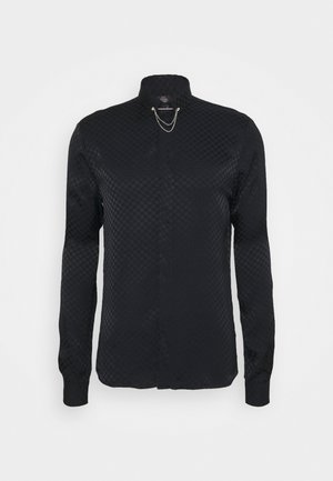 Maglietta nera a maniche lunghe con un motivo testurizzato, colletto alla cinese e una catena decorativa sul davanti, con un taglio dritto all'orlo.