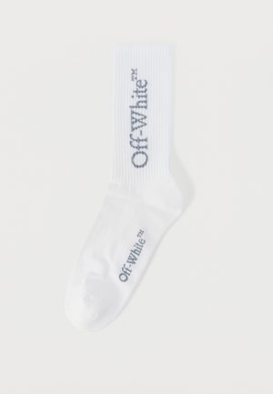 White crew sock with black "Off-White" text printed vertically on the calf and horizontally near the toe area.