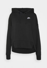 Zwarte oversized hoodie van zacht katoen met een voorzak in kangoeroestijl, een verstelbare capuchon en een wit Nike-logo op de borst.