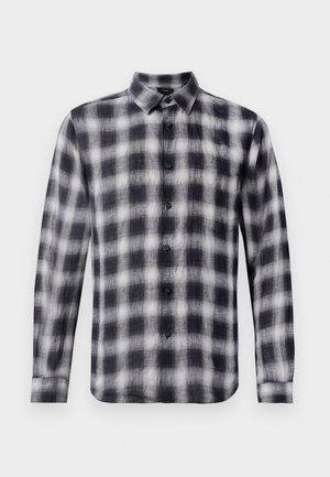 Camisa de cuadros en blanco y negro, de manga larga, con cuello, hecha de una tela ligera con una textura suave, con botones negros.