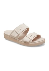 Beige slipper sandalen met twee brede banden, een gestructureerde voetbed en een lichte plateauzool. Gemaakt van een rubberachtig materiaal, met subtiele logo accenten.