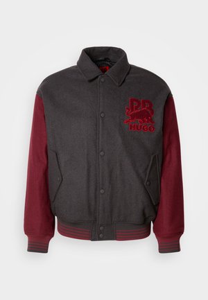 Gray wool-blend bomber jacket with maroon sleeves, ribbed cuffs, and waistband. Features a front logo patch and snap button closure.