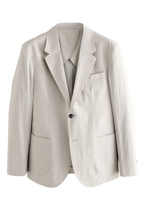 Ljusbeige herrblazer i strukturerat tyg, med hakskårna slag, en svart knapp och påsydda fickor framtill.