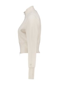 Beige, fitted zip-up jacket with high collar, long sleeves, and a subtle textured surface; features a small logo on the cuff.