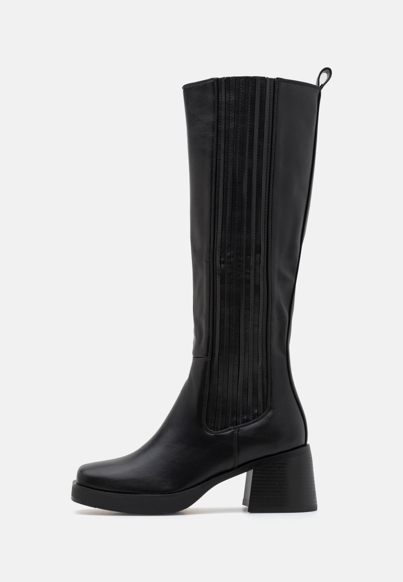 Black knee-high boot made of smooth leather, featuring vertical ribbed accents, a chunky block heel, and a rounded toe design.