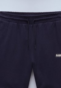 Pantalons de jogging bleu marine en mélange de coton doux, dotés d'une taille élastique, d'un cordon de serrage et d'un petit logo sur le côté gauche.
