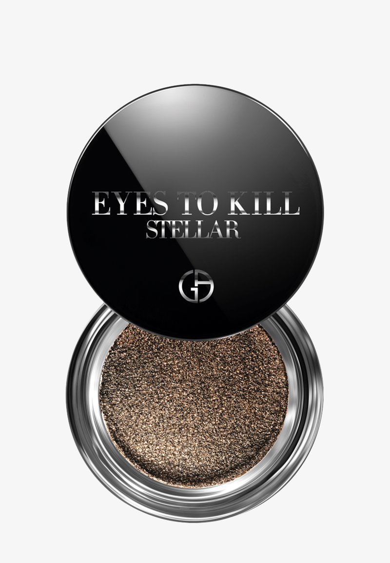 Oogschaduw in een ronde, zwarte compacte verpakking met zilveren accenten. Bevat een gestructureerde, bronzen pigment. De deksel heeft de tekst "EYES TO KILL STELLAR."