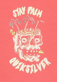 Koral t-shirt med grafik af et kranium med palmer, en cocktail og farverig tekst, der siger "STAY PALM QUIKSILVER" i lyse farver.