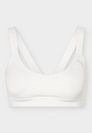 Brassière de sport blanche avec de larges bretelles croisées dans le dos et un logo Puma discret sur le côté droit à l'avant.