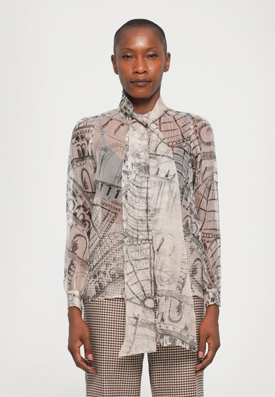 Sheer, patterned blouse with a tie collar in beige and gray tones, featuring architectural sketches. Long sleeves with button cuffs.
