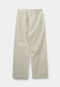 Svītrainas bēšas bikses ar elastīgu jostu. Izgatavotas no mīkstas auduma, ar vertikālām līnijām un brīvu piegriezumu, kas sasniedz potītes.