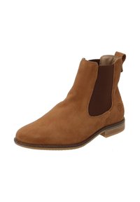 Stivale Chelsea in suede marrone con pannelli laterali elasticizzati, punta arrotondata e tacco basso impilato. Presenta un tassello nella parte posteriore per facilitarne l'indossamento.